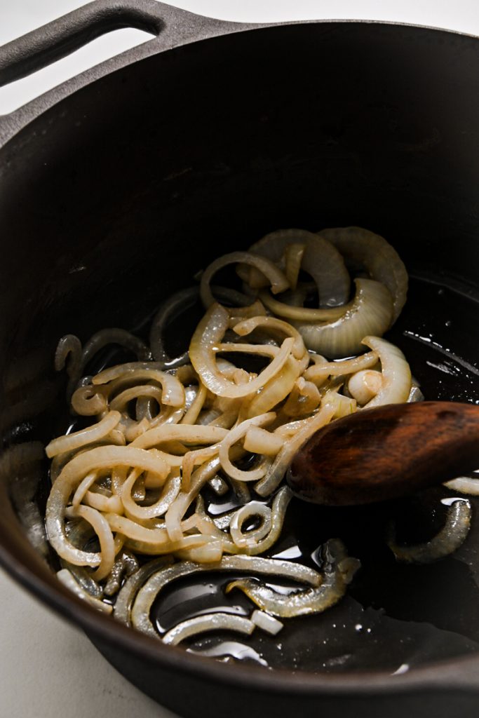 Onions sautéing in a large pot.