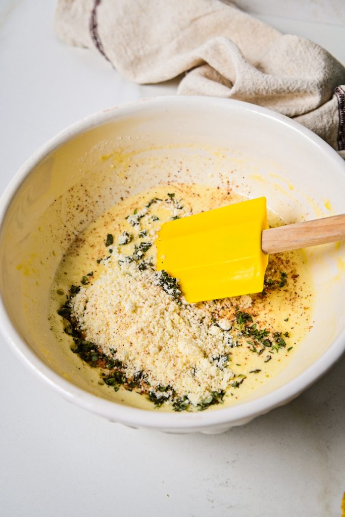 Parmesan cheese, flour, baking powder and herbs added to the egg mixture.