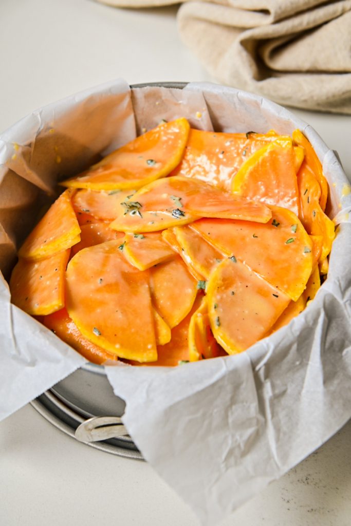 Butternut squash invisible cake batter placed in a parchment like cake pan.