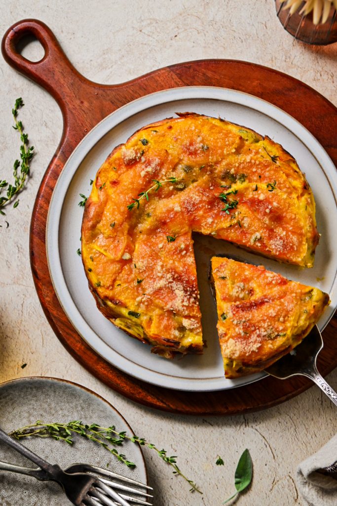 Overhead shot of butternut squash invisible cake with a slice being taken by a spatula.
