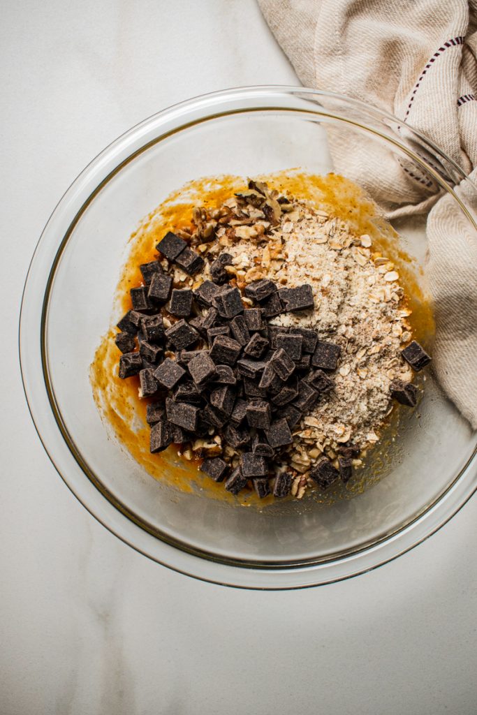 Pumpkin mixture with the dry ingredients and chocolate being added.