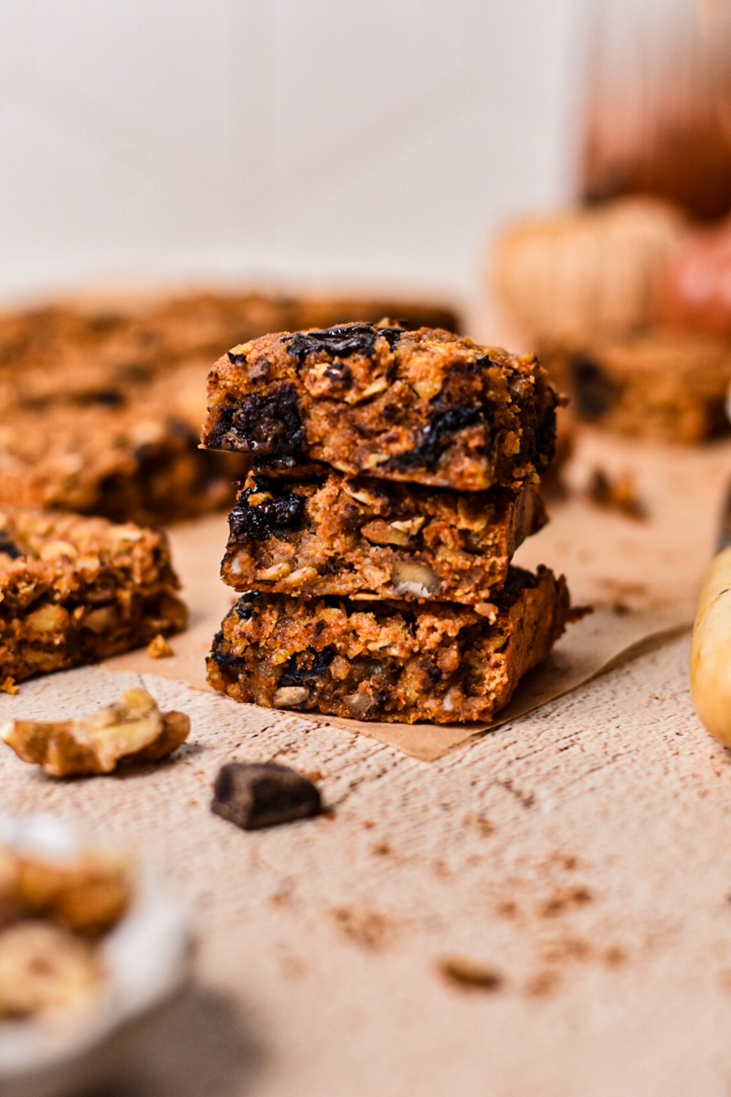 Three pieces of pumpkin chocolate baked oats stacked on top of eachother.