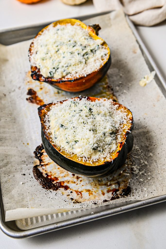 Acorn squash halves stuffed with creamed kale and topped with parmesan before roasting again.