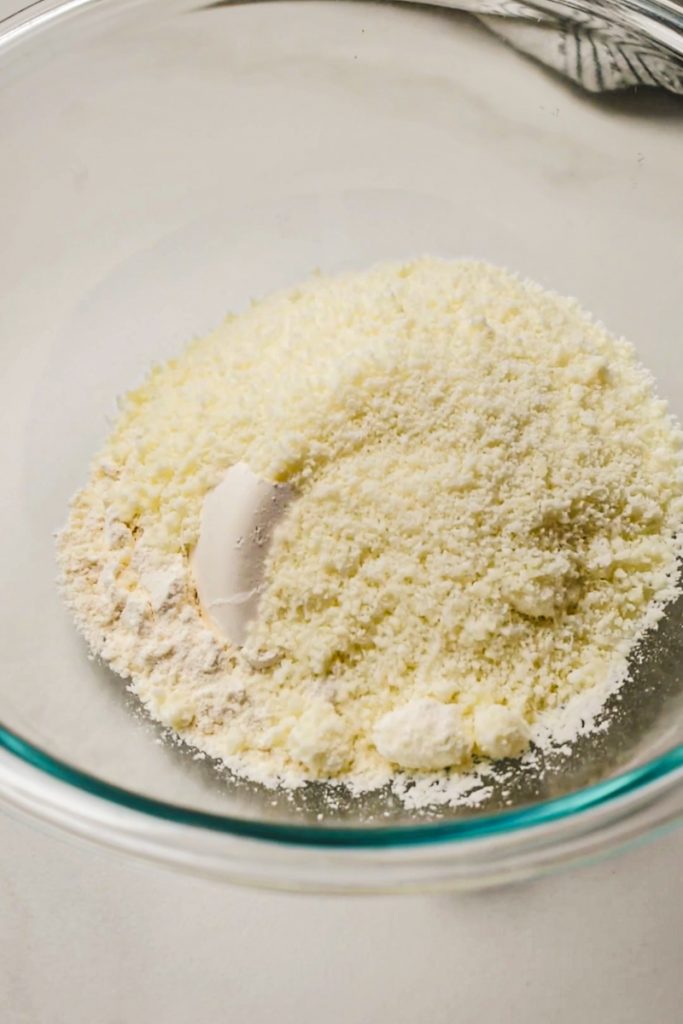 Flour and parmesan measured out into a mixing bowl.