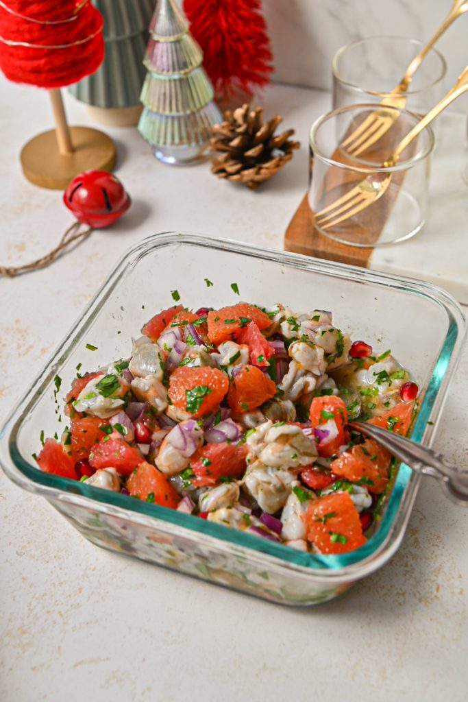 Winter citrus pomegranate shrimp ceviche all mixed together in a glass container.