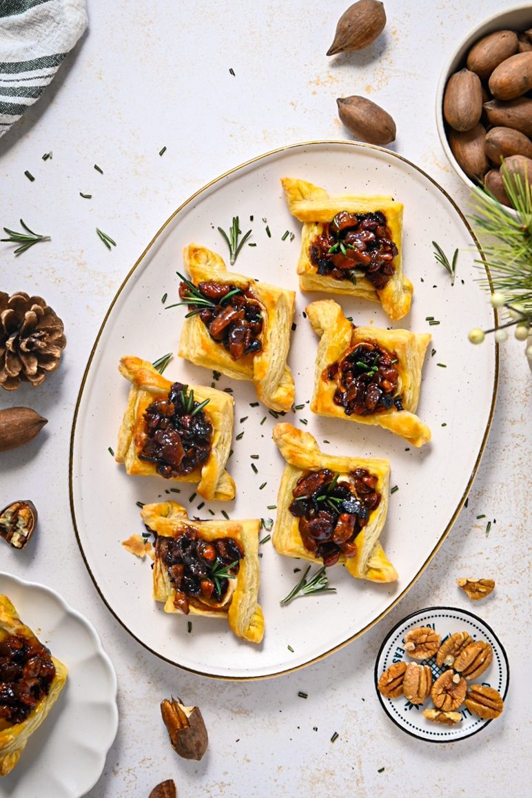 Overhead shot of pecan brie bourbon bacon bites on a serving platter.