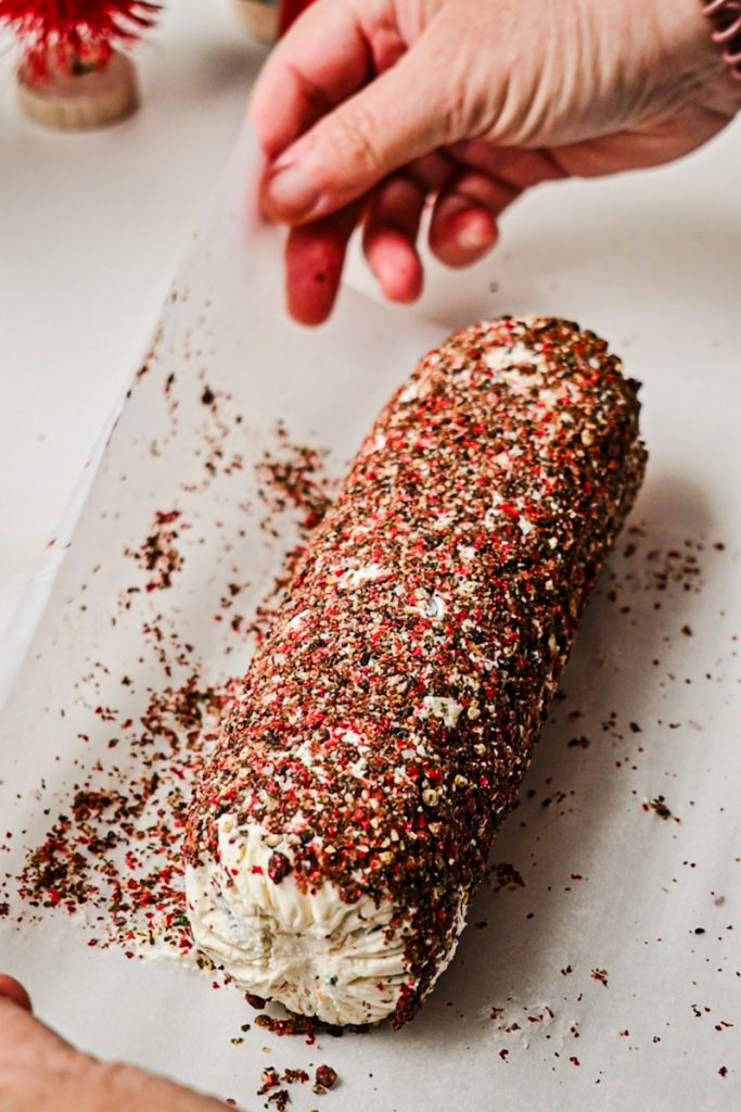 Cheese log dipped in crushed peppercorns.